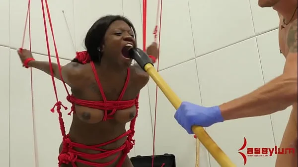 Bound ebony submissive from ceiling